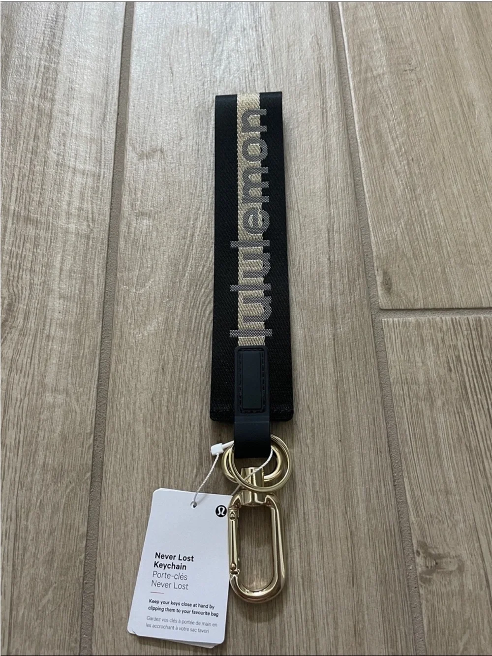 NWT Never Lost Keychain Black/ Gold Wordmark O/S